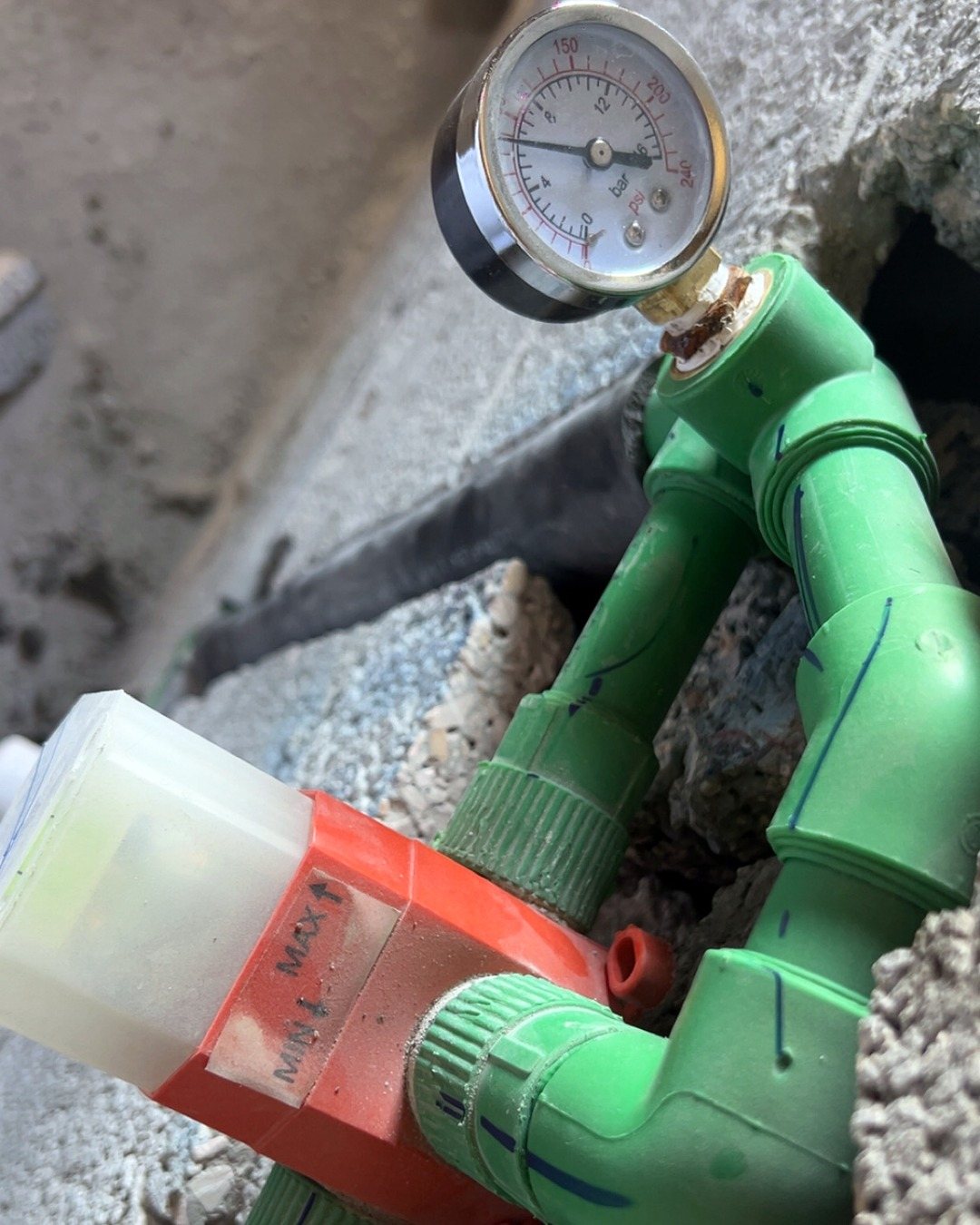 A pressure gauge fitted on green water pipe joints during a pressure test